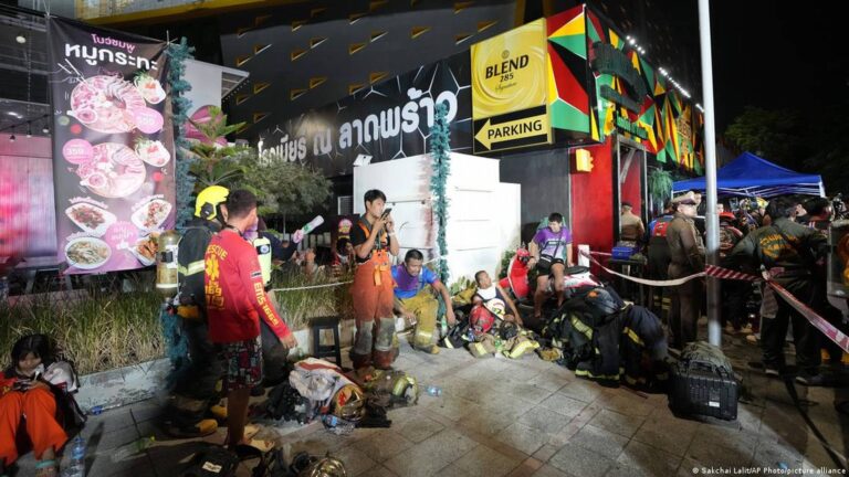 Firefighters and investigators at the Bangkok bar fire scene in Chatuchak district after the deadly blaze.