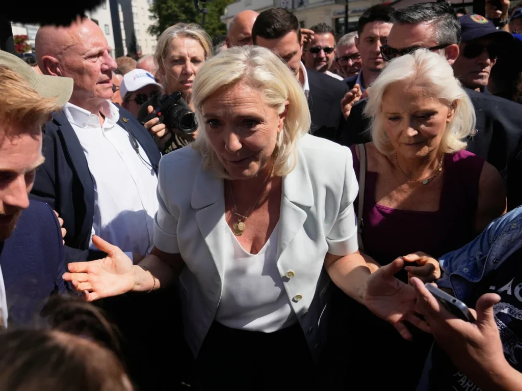 Marine Le Pen greets supporters during her 2027 French presidential campaign after launching her comeback following a court ruling.