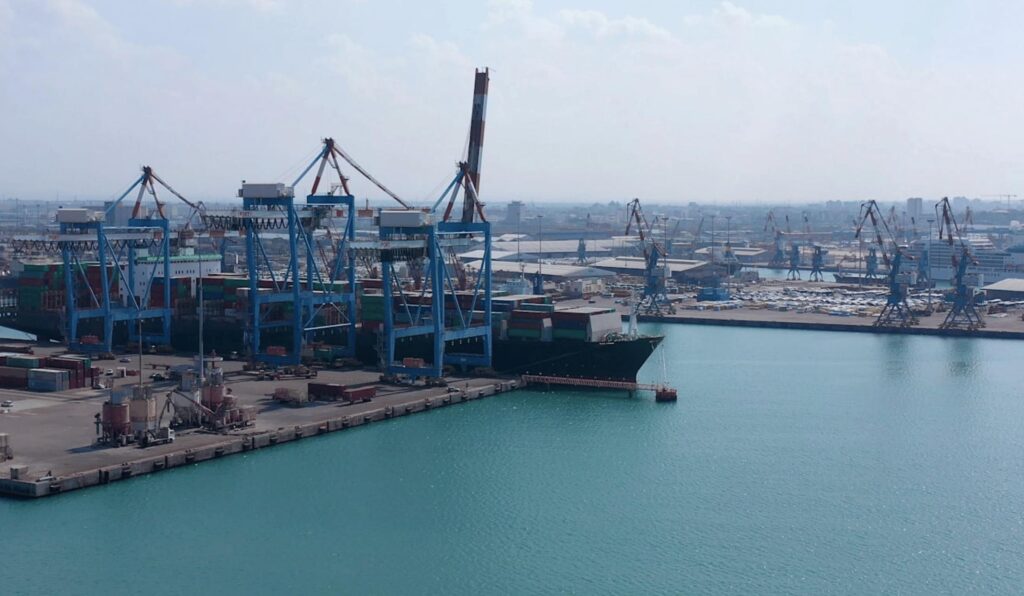 Red Sea commercial port with cargo ships and container cranes